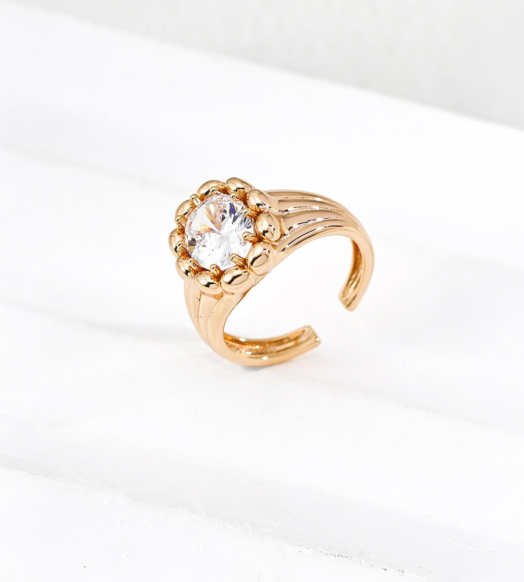 Vintage Gold sculptural open ring with round cubic zirconia, polished bead surround and grooved shoulders.