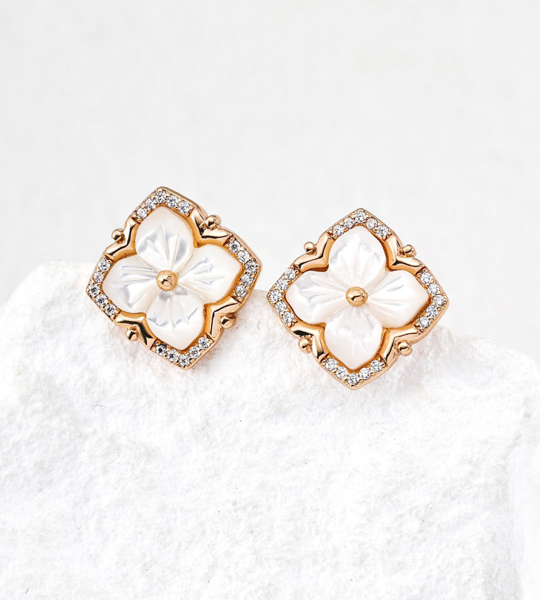 A pair of 18K Gold Plated S925 Silver floral stud earrings with white mother-of-pearl flower centers and cubic zirconia halos