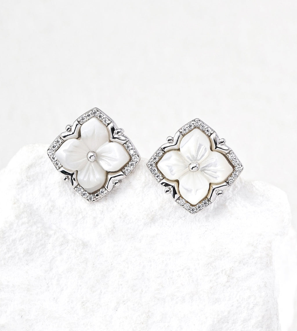 A pair of 18K White Gold Plated S925 Silver floral stud earrings with white mother-of-pearl flower centers and cubic zirconia halos