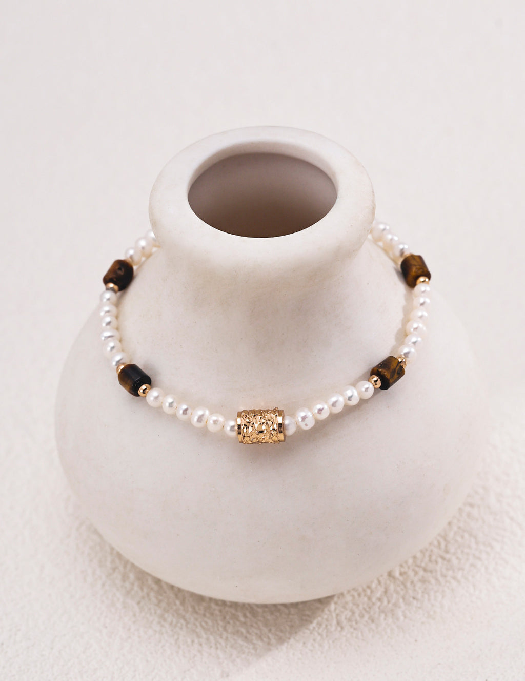 Natural pearl and tiger's eye beaded bracelet in vintage gold styled with tiger's eye heart CZ drop earrings — freshwater pearls, filigree barrel bead, rectangular tiger's eye beads, 18K gold plated S925 silver, BUCKLE Collective