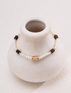 Natural pearl and tiger's eye beaded bracelet in vintage gold styled with tiger's eye heart CZ drop earrings — freshwater pearls, filigree barrel bead, rectangular tiger's eye beads, 18K gold plated S925 silver, BUCKLE Collective