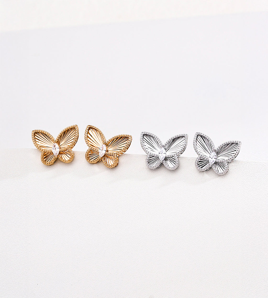 CNC embossed butterfly stud earrings in vintage gold and silver-tone — precision 3D sculpted wings with beaded border and marquise CZ centre, 18K plated S925 sterling silver, BUCKLE Collective