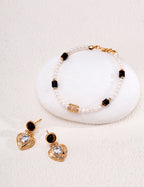 Natural pearl and tiger's eye beaded bracelet in vintage gold styled with tiger's eye heart CZ drop earrings — freshwater pearls, filigree barrel bead, rectangular tiger's eye beads, 18K gold plated S925 silver, BUCKLE Collective