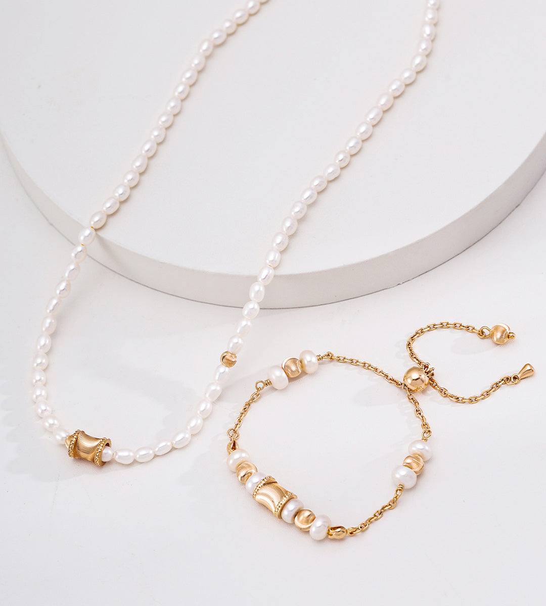 Adjustable freshwater pearl bracelet in vintage gold styled with pearl necklace — wasp-waist charm, round polished beads, pull-slide clasp, 18K gold plated S925 silver, BUCKLE Collective