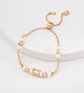 Adjustable freshwater pearl bracelet in 18K vintage gold — wasp-waist engraved charm, natural freshwater pearls, round spacer beads, pull-slide clasp, S925 sterling silver, BUCKLE Collective