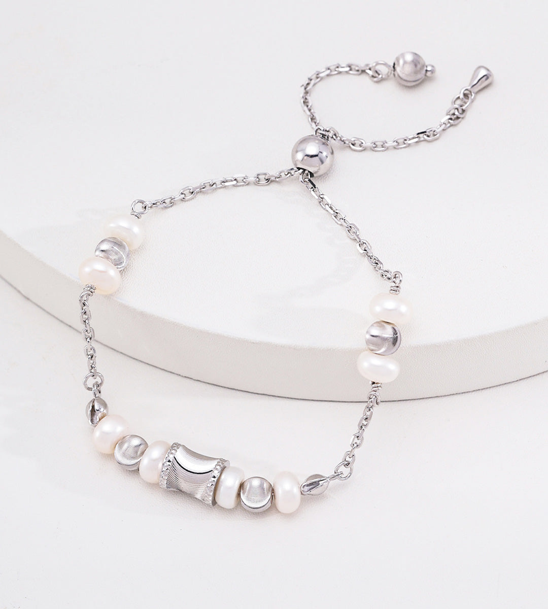 Adjustable freshwater pearl bracelet in white gold silver — wasp-waist charm, round spacer beads, pull-slide slider clasp, S925 sterling silver, BUCKLE Collective

