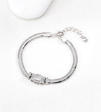Silver-tone flat snake chain bracelet with a rectangular cubic zirconia centre and small side accents, showing its lobster clasp and extender.