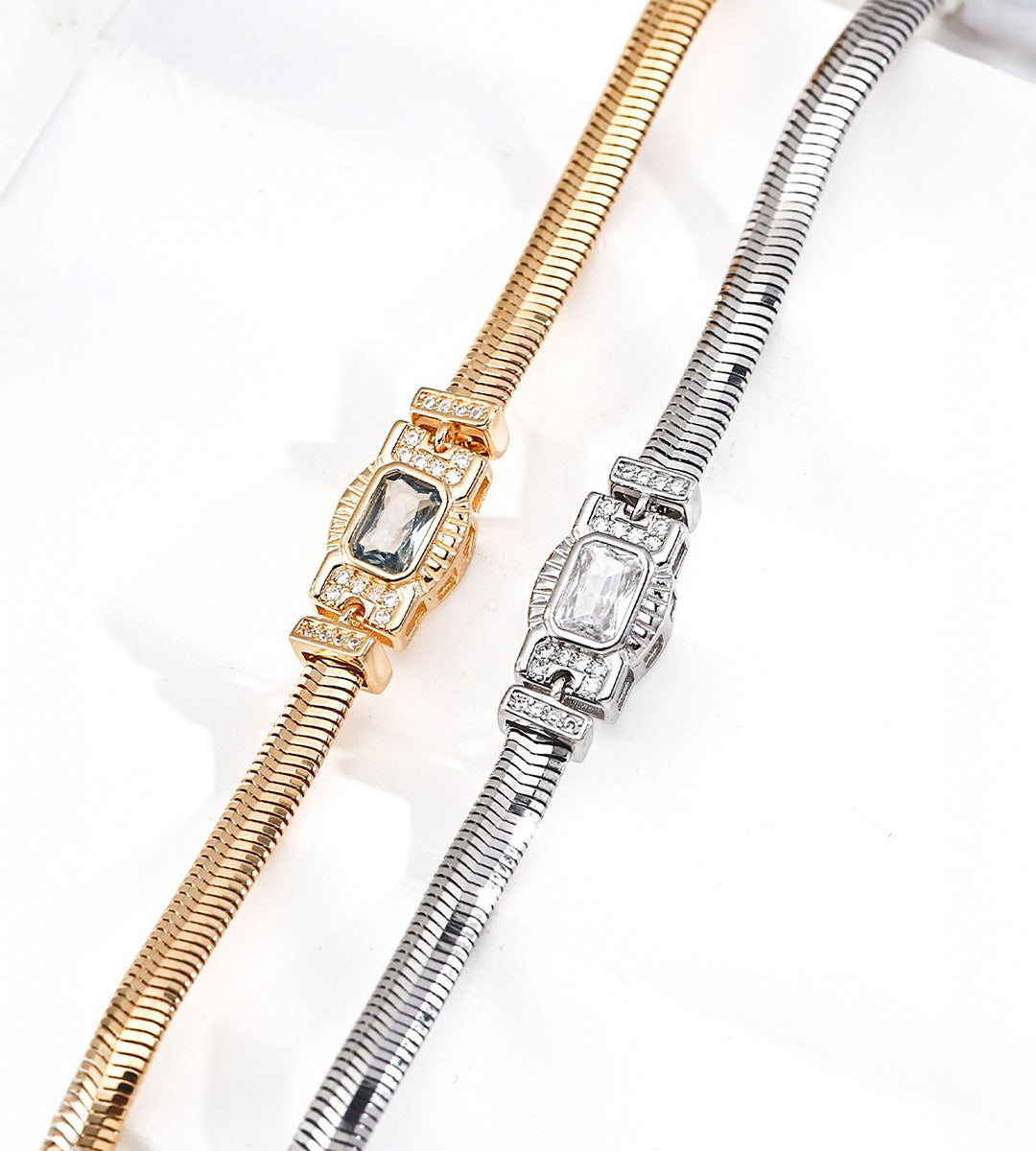 Close-up of Vintage Gold and silver-tone snake chain bracelets, showing rectangular cubic zirconia centres and sparkling geometric side details.