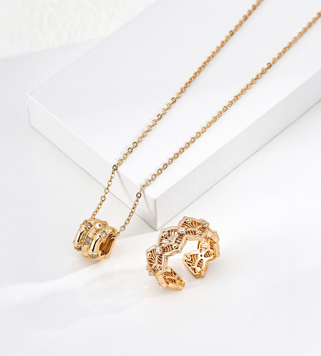 18K gold-plated S925 silver bamboo-barrel CZ necklace displayed beside a gold-tone openwork ring.