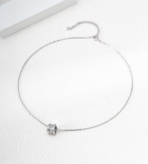 White Gold-finish bamboo-barrel cubic zirconia necklace with a fine chain and extender on a white surface.
