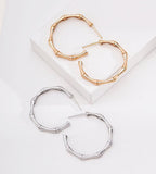 Two hoop earrings with a bamboo-inspired segmented design, shown on a clean white background. One pair is 18K gold-plated, and the other is 18K White gold-plated.