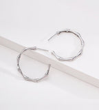 A pair of 18K White-Gold-Plated S925 silver hoop earrings with a bamboo branch link design