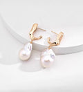 18K gold-plated S925 sterling silver baroque pearl drop earrings with sculptural tops on a white display