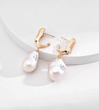18K gold-plated S925 sterling silver baroque pearl drop earrings with sculptural tops on a white display