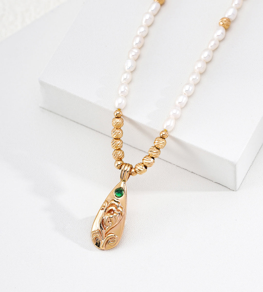 Close view on a Natural Baroque Seed Pearl Necklace with Engraved Floral Pendant, 18K Gold-Plated over S925 Sterling Silver, Vintage Gold Color