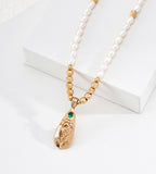 Close view on a Natural Baroque Seed Pearl Necklace with Engraved Floral Pendant, 18K Gold-Plated over S925 Sterling Silver, Vintage Gold Color