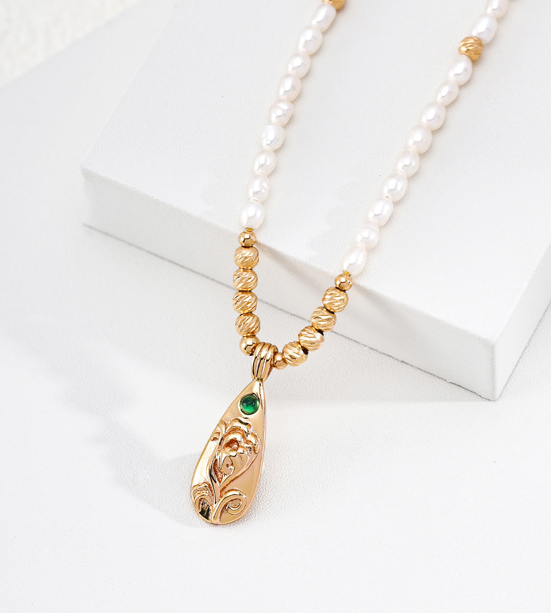 Close view on a Natural Baroque Seed Pearl Necklace with Engraved Floral Pendant, 18K Gold-Plated over S925 Sterling Silver, Vintage Gold Color