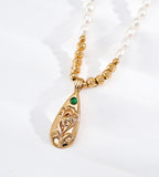 Close-up photo on Natural Baroque Seed Pearl Necklace with Engraved Floral Pendant with a Green Zircon, 18K Gold-Plated over S925 Sterling Silver