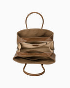A brown leather tote bag shown open from the front, displaying its interior compartments, zippered pocket, and tan lining