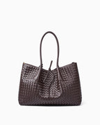 A dark brown woven leather large tote bag with double top handles and a drawstring detail