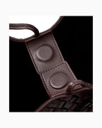 Close-up detail of a magnetic closure and stitching of a dark brown woven leather large tote bag