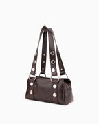 Side view of the Brown Vegan Leather Handbag with Oversized Rivet accents