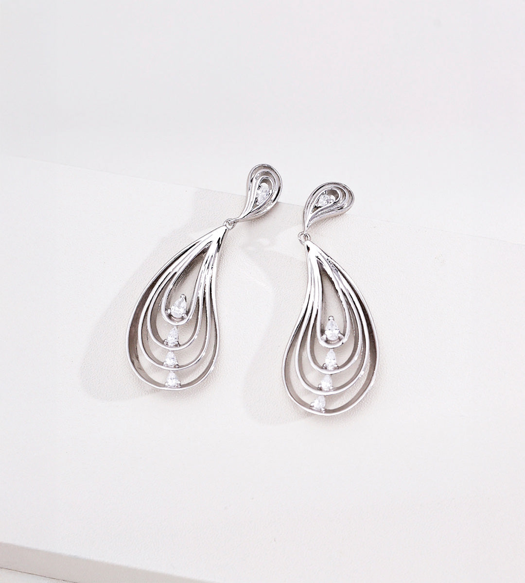 18K White-Gold-Plated S925 Silver Layered Wing Drop Earrings with small cubic zirconia accents, displayed on a clean white surface.