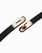 Close-up of a turn-lock buckle of a classic saffiano slim leather belt