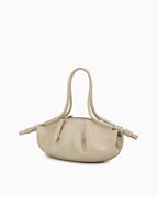 Side view of the Beige Pleated Leather Dumpling Handbag with Knotted Strap
