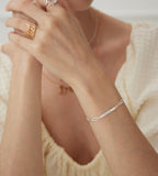 Model wearing "Your Name" Custom Letter Bracelet on the wrist, 925 Sterling Silver, 18K Gold-plated