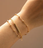"Your Name" Custom Letter Bracelet on a wrist, 925 Sterling Silver, 18K Gold-plated 