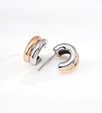 A pair of modern stacked hoop earrings with a two-tone 18K gold-plated finish over S925 silver displayed on a clean white background.