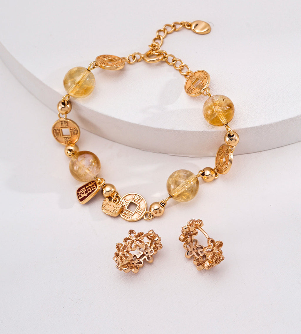 Floral hollow-carved huggie hoop earrings in vintage gold with matching citrine coin charm bracelet — 18K gold plated S925 silver jewellery set, BUCKLE Collective