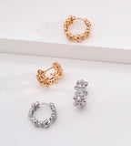 Floral hollow-carved huggie hoop earrings in vintage gold and white gold — CZ flower hoop both colourways comparison, 18K gold plated S925 sterling silver, BUCKLE Collective