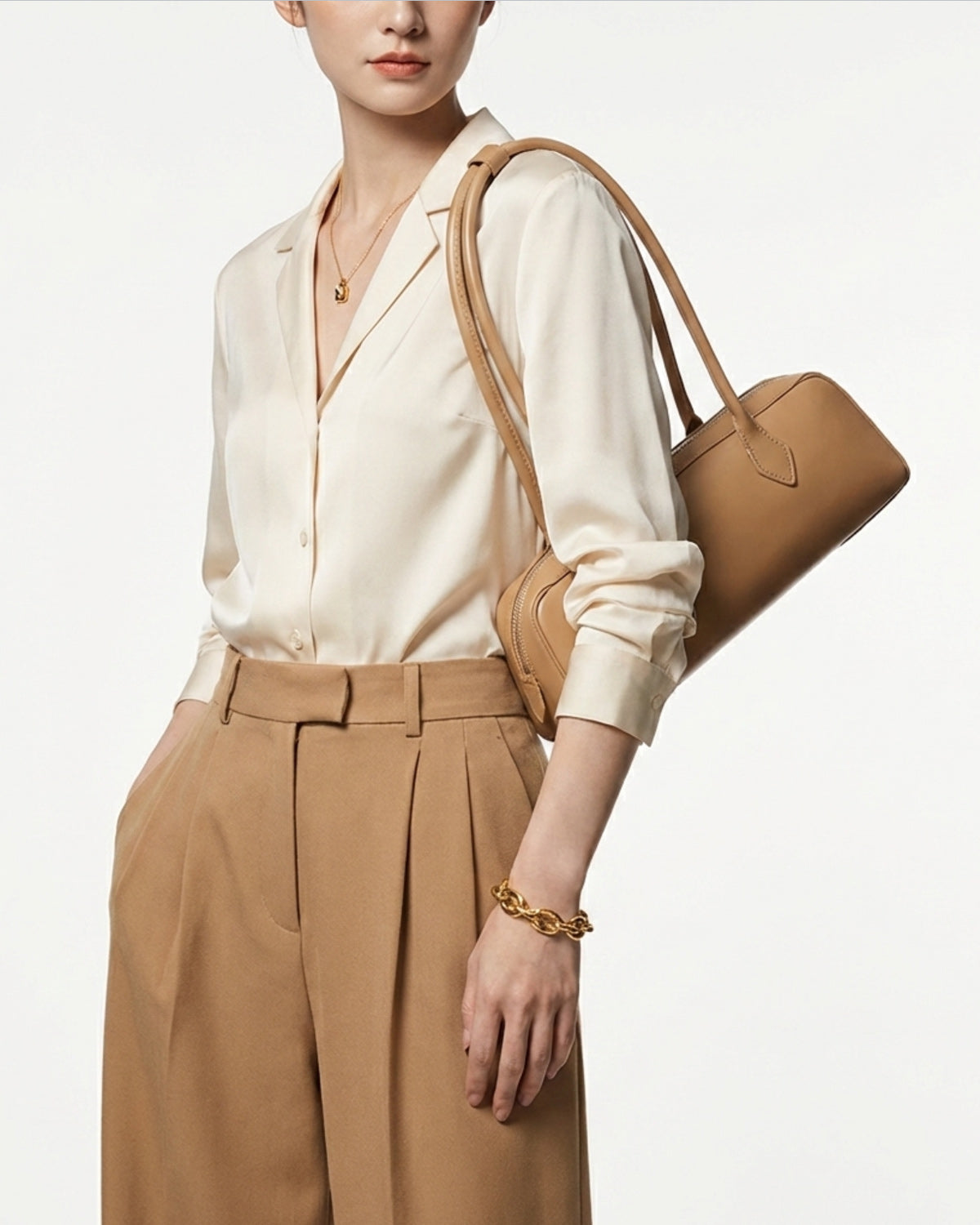 Woman wearing a stylish smart-casual outfit with a Leather Baguette Handbag in Apricot Color