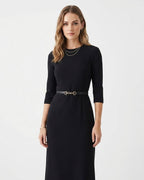 A woman modeling a black three-quarter sleeve midi dress with a matching black slim classic leather belt featuring a gold buckle