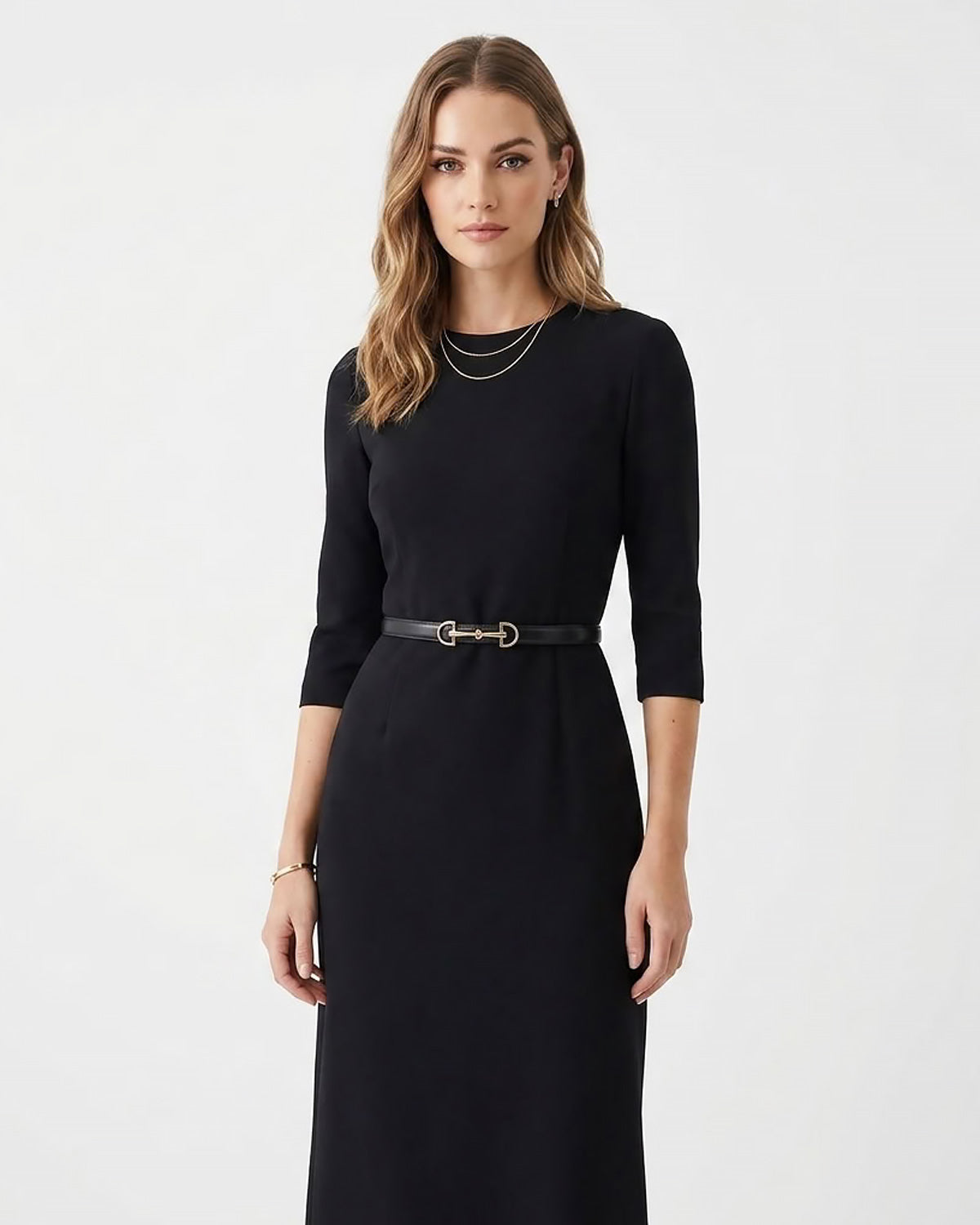 A woman modeling a black three-quarter sleeve midi dress with a matching black slim classic leather belt featuring a gold buckle