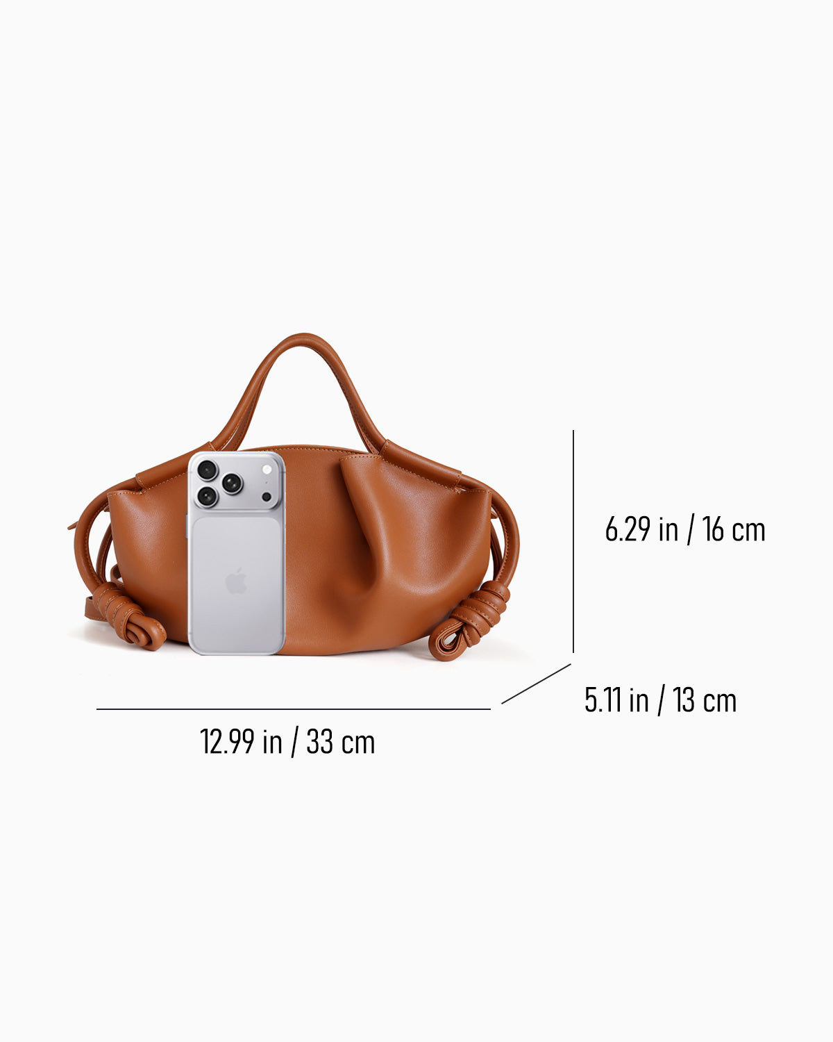 Dumpling Handbag with Knotted Strap shown on a light gray background with overlaid dimension lines and measurements indicating width, height, and depth, plus a smartphone used for scale.