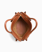 Top view of a brown leather dumpling handbag showing its interior, handles, and zipper closure | BUCKLE Collective