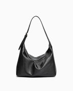 A black leather slouchy Hobo bag with a single adjustable strap, photographed against a plain white background.