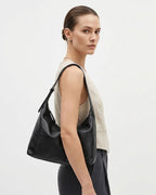 Woman in a stylish smart-casual outfit with a Black Genuine Leather Slouchy Hobo Bag