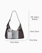 Dark brown leather slouchy Hobo bag shown with overlaid dimension lines and measurements for width, height, and depth, alongside a phone and tablet for scale, on a light gray background.