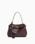 A dark burgundy leather handbag with a top handle, a detachable shoulder strap, and a gold-tone turn-lock clasp on a plain white background.