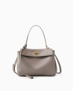 An elephant gray leather handbag with a top handle, a detachable shoulder strap, and a gold-tone turn-lock clasp on a plain white background.