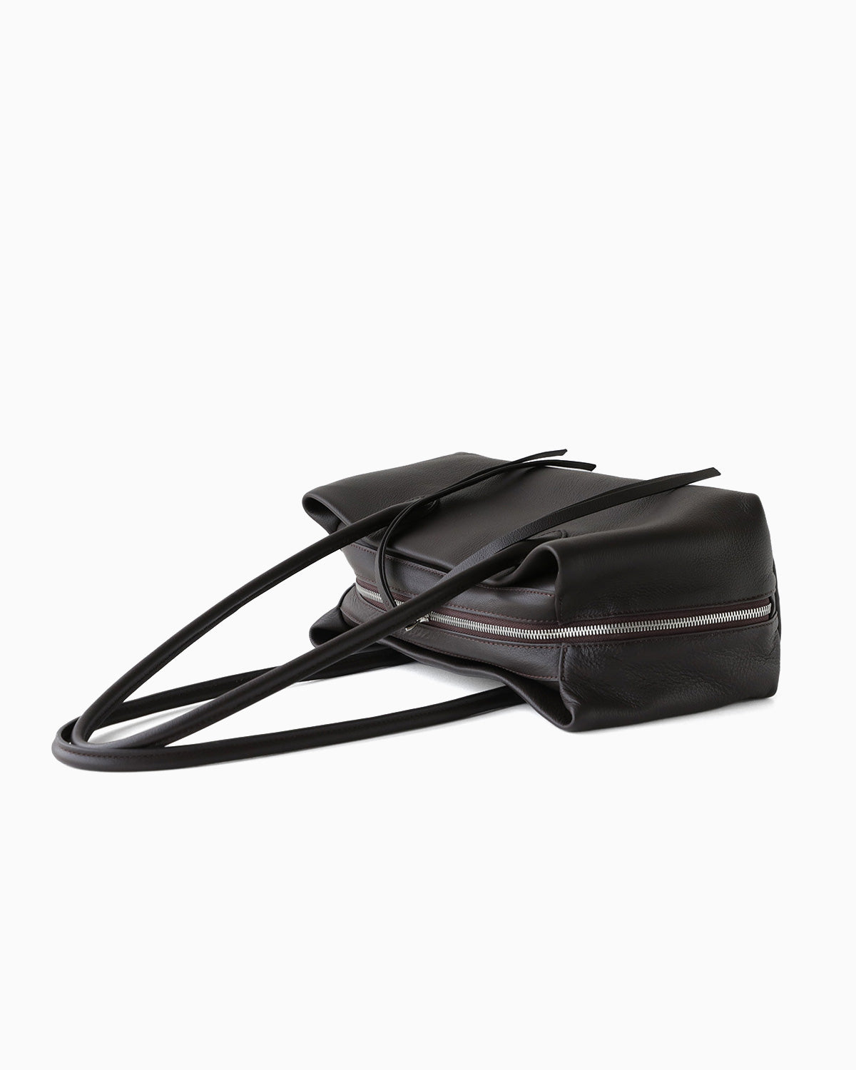 A side view on a Dark Coffee Brown Genuine Full-Grain Leather Commuter Shoulder Bag by BUCKLE Collective