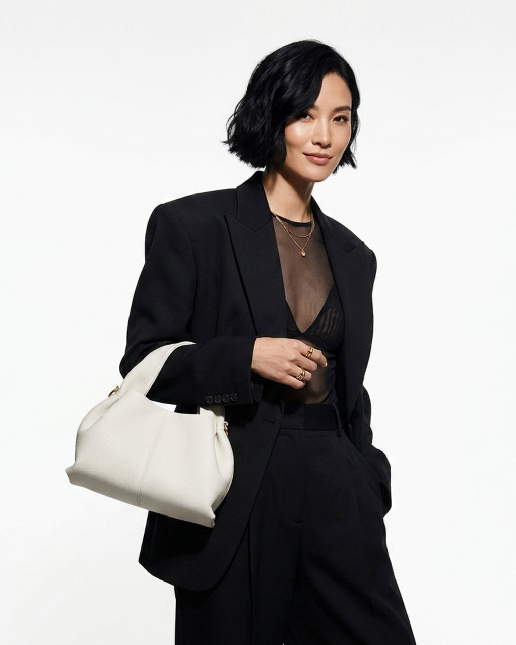 A woman in a fashion-forward evening date black outfit with Off-White Genuine Leather Cloud-shaped Satchel Handbag 