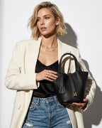 Stylish woman with Genuine Togo Leather Bucket Bag with Lock and Key, Bag in Black color with White stitching