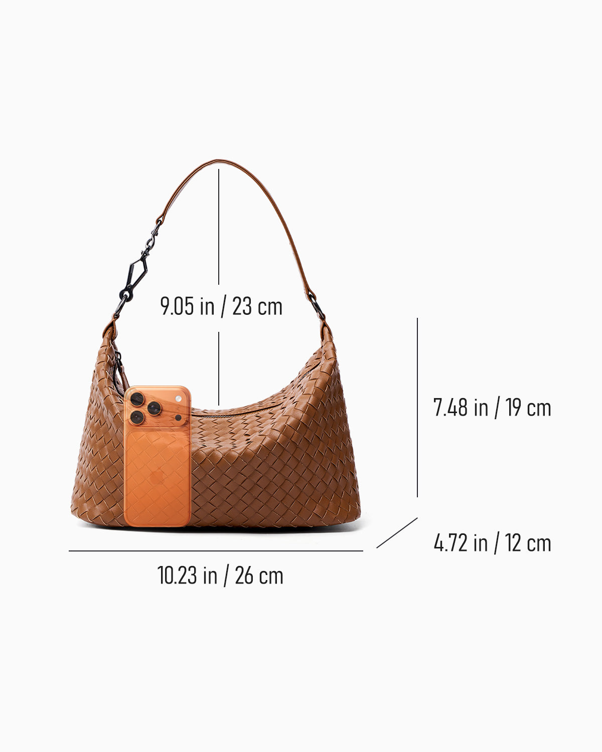 A light brown woven shoulder bag shown on a light gray background with overlaid dimension lines and measurements for width, height, and strap length, plus a phone placed iin fornt of the bag for scale.