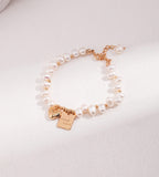 Good Luck baroque freshwater pearl bracelet in vintage gold — engraved "Good Luck" square tag and heart charm, 18K gold plated S925 sterling silver, adjustable lobster clasp, BUCKLE Collective
