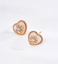 Vintage Gold heart-shaped mother of pearl stud earrings with sparkling cubic zirconia flower accents and textured beaded borders.